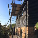 Scaffold with boards and ladder